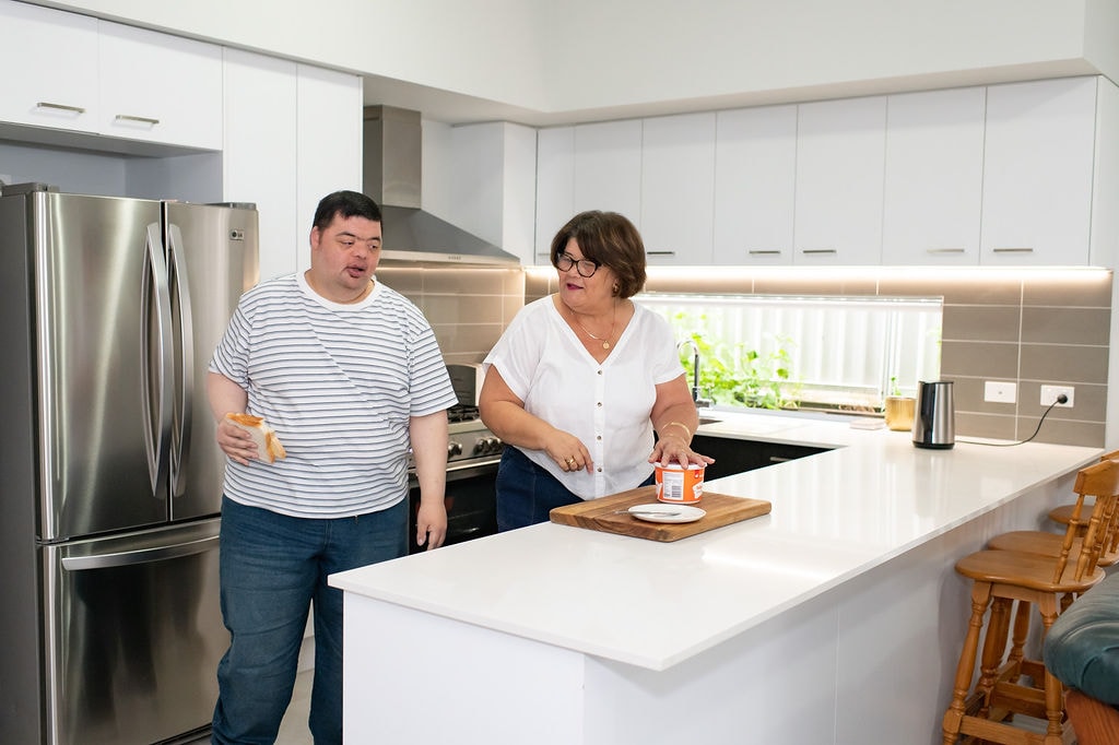 Kathleen Browne and her son preparing food together in their kitchen